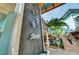 Exterior view of Sharky's with stairs, a waterfall feature, and palm trees at 510 Airport E Ave # 2D, Venice, FL 34285