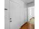 Hallway featuring wood flooring, a key rack and a doorway to other rooms at 510 Airport E Ave # 2D, Venice, FL 34285