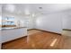 Open living space featuring hardwood flooring, a ceiling fan and a bar counter at 510 Airport E Ave # 2D, Venice, FL 34285