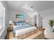 Inviting main bedroom featuring a woven bed frame, coastal decor, and plenty of natural light at 510 Airport E Ave # 2D, Venice, FL 34285