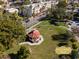 Aerial view of Centennial Park with a gazebo, lawn, trees, and surrounding buildings at 510 Airport E Ave # 2D, Venice, FL 34285