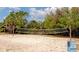 Beach volleyball court ready for a friendly game amid a scenic park setting with lush green trees at 510 Airport E Ave # 2D, Venice, FL 34285