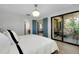 Bright main bedroom featuring tile floors, modern decor, and access to the screened in lanai at 5138 Harpers Croft # 12, Sarasota, FL 34235