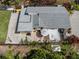 Aerial view of the property showcasing the backyard patio with an umbrella, outdoor seating, and lush greenery at 514 Pameto Rd, Nokomis, FL 34275