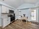 Well-lit kitchen featuring modern appliances, white cabinets, and adjacent dining area at 514 Pameto Rd, Nokomis, FL 34275
