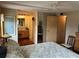 Bedroom featuring wood floors and attached bathroom with vanity at 530 Via Veneto, Venice, FL 34285