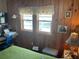 Bright bedroom with two windows and wood-paneled walls at 530 Via Veneto, Venice, FL 34285