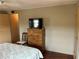 Bedroom featuring a wood dresser and flatscreen television at 530 Via Veneto, Venice, FL 34285