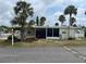 This cozy one-story home features a screened in porch and is beautifully landscaped with palm trees at 530 Via Veneto, Venice, FL 34285