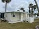 This cozy one-story home features a back patio and is surrounded by lovely palm trees at 530 Via Veneto, Venice, FL 34285