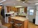 Well-lit kitchen featuring wood cabinets, stainless steel appliances, and a large island perfect for food preparation at 530 Via Veneto, Venice, FL 34285