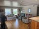A cozy living room with hardwood flooring, plush seating, and natural lighting at 530 Via Veneto, Venice, FL 34285