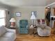 Cozy living room featuring comfortable seating, neutral tones, and laminate wood flooring, ideal for relaxation at 530 Via Veneto, Venice, FL 34285
