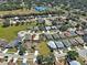 Aerial view of a home surrounded by lush greenery and well-maintained landscaping at 589 Rose Apple Circle, Port Charlotte, FL 33954