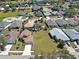 Aerial view of a residential neighborhood featuring well-maintained lawns and mature trees at 589 Rose Apple Circle, Port Charlotte, FL 33954