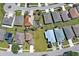Aerial view of a home showcasing backyard with pool surrounded by lush landscaping and neighborhood at 589 Rose Apple Circle, Port Charlotte, FL 33954