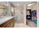 View of bathroom with tiled shower and open walk-in closet at 589 Rose Apple Circle, Port Charlotte, FL 33954