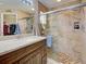 Elegant bathroom features a tiled shower, glass door, and dark wood vanity at 589 Rose Apple Circle, Port Charlotte, FL 33954