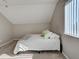 Bright bedroom with carpet flooring, angled ceilings, and large window at 589 Rose Apple Circle, Port Charlotte, FL 33954