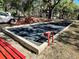 Bocce ball court with a paved area and red benches at 589 Rose Apple Circle, Port Charlotte, FL 33954