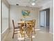 Comfortable dining area features a wood table and seating for four at 589 Rose Apple Circle, Port Charlotte, FL 33954