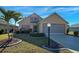 Inviting single-Gathering home displays a lush green lawn and mature landscaping at 589 Rose Apple Circle, Port Charlotte, FL 33954