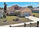 Home's exterior with well-maintained lawn, complemented by a paved driveway leading to a two-car garage at 589 Rose Apple Circle, Port Charlotte, FL 33954