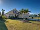 Single-Gathering home displays lush green lawn and palm tree in meticulously maintained front yard at 589 Rose Apple Circle, Port Charlotte, FL 33954