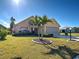 Exterior of a well-maintained two-story home showcasing manicured landscaping and healthy green grass at 589 Rose Apple Circle, Port Charlotte, FL 33954