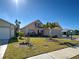 Charming two-story home with landscaped yard, sunny day, and well-maintained lawn at 589 Rose Apple Circle, Port Charlotte, FL 33954