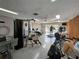Well-equipped fitness center with modern exercise machines, ceiling fan, and plenty of natural light at 589 Rose Apple Circle, Port Charlotte, FL 33954