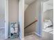 Hallway featuring a staircase with a view of a bedroom with a white bed and comforter at 589 Rose Apple Circle, Port Charlotte, FL 33954