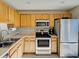 Bright kitchen with stainless steel appliances and light wood cabinets at 589 Rose Apple Circle, Port Charlotte, FL 33954