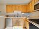 This kitchen features warm oak cabinets and stainless steel appliances at 589 Rose Apple Circle, Port Charlotte, FL 33954