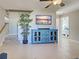 Bright living room with tile floors and a decorative cabinet under the TV at 589 Rose Apple Circle, Port Charlotte, FL 33954