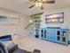 Cozy living room with tile floors and a stylish blue entertainment center at 589 Rose Apple Circle, Port Charlotte, FL 33954