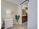 Bedroom with a sliding barn door that opens to the bathroom with a wood vanity at 589 Rose Apple Circle, Port Charlotte, FL 33954