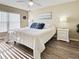 Serene main bedroom with modern flooring, bright lighting, and a plush queen-sized bed at 589 Rose Apple Circle, Port Charlotte, FL 33954
