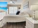 Well-lit main bedroom featuring a beach view on TV and coastal-themed decor at 589 Rose Apple Circle, Port Charlotte, FL 33954