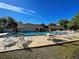 Community pool with ample seating and lounge chairs under a bright blue sky at 589 Rose Apple Circle, Port Charlotte, FL 33954