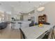 Open kitchen view featuring granite countertops, bar seating, and a combined dining area at 611 Sawgrass Bridge Rd, Venice, FL 34292