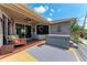 Relaxing backyard featuring a hot tub, comfortable seating, and serene views of the tropical landscape at 740 Tanager Rd, Venice, FL 34293