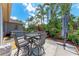 Charming backyard with an outdoor dining area, tropical plants, and a cozy solo stove area at 740 Tanager Rd, Venice, FL 34293