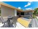 Inviting backyard featuring a dining set, hot tub, and sliding doors to the cozy covered patio at 740 Tanager Rd, Venice, FL 34293
