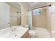 Cozy bathroom featuring a shower-tub combo, tile surround, and a large mirror above the sink at 740 Tanager Rd, Venice, FL 34293