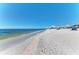 Beautiful beach view with clear blue skies, calm waters, and people enjoying the sunny day at 740 Tanager Rd, Venice, FL 34293