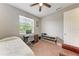 Bright bedroom with a ceiling fan, natural light, and functional home office space at 740 Tanager Rd, Venice, FL 34293