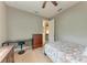 Bedroom featuring wood floors, a neutral color palette, and comfortable furnishings at 740 Tanager Rd, Venice, FL 34293