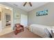 Bedroom featuring wood floors, a ceiling fan, and a view into the hallway at 740 Tanager Rd, Venice, FL 34293