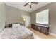 Comfortable bedroom with neutral walls, a ceiling fan, and natural light at 740 Tanager Rd, Venice, FL 34293
